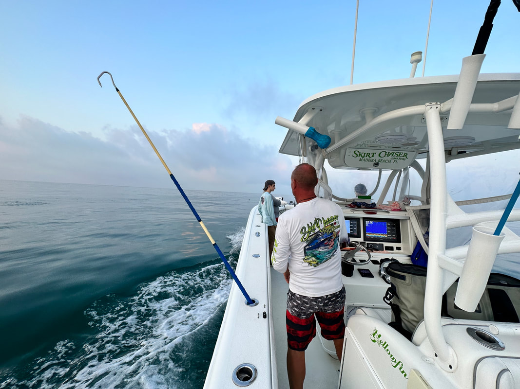 Anglers fighting a tuna on the back deck